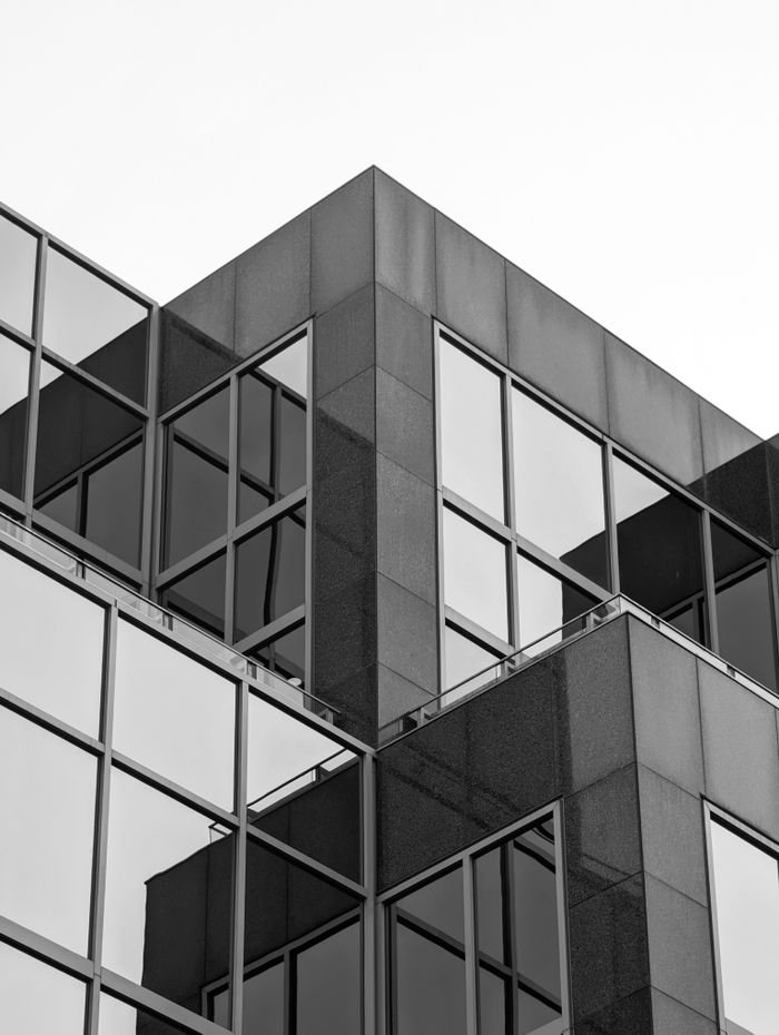 services-03 Black and white view of modern glass architecture in Halifax city capturing urban elegance.
