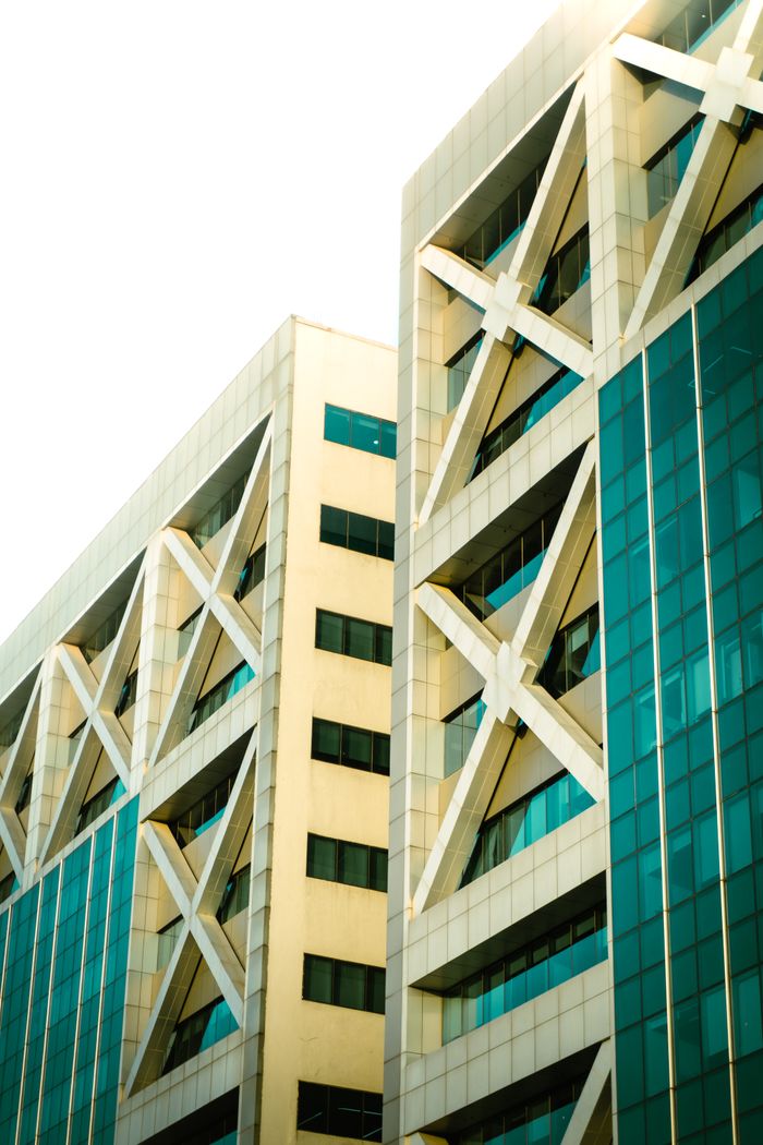 why-choose-us Close-up view of a modern building facade with geometric patterns and glass elements.